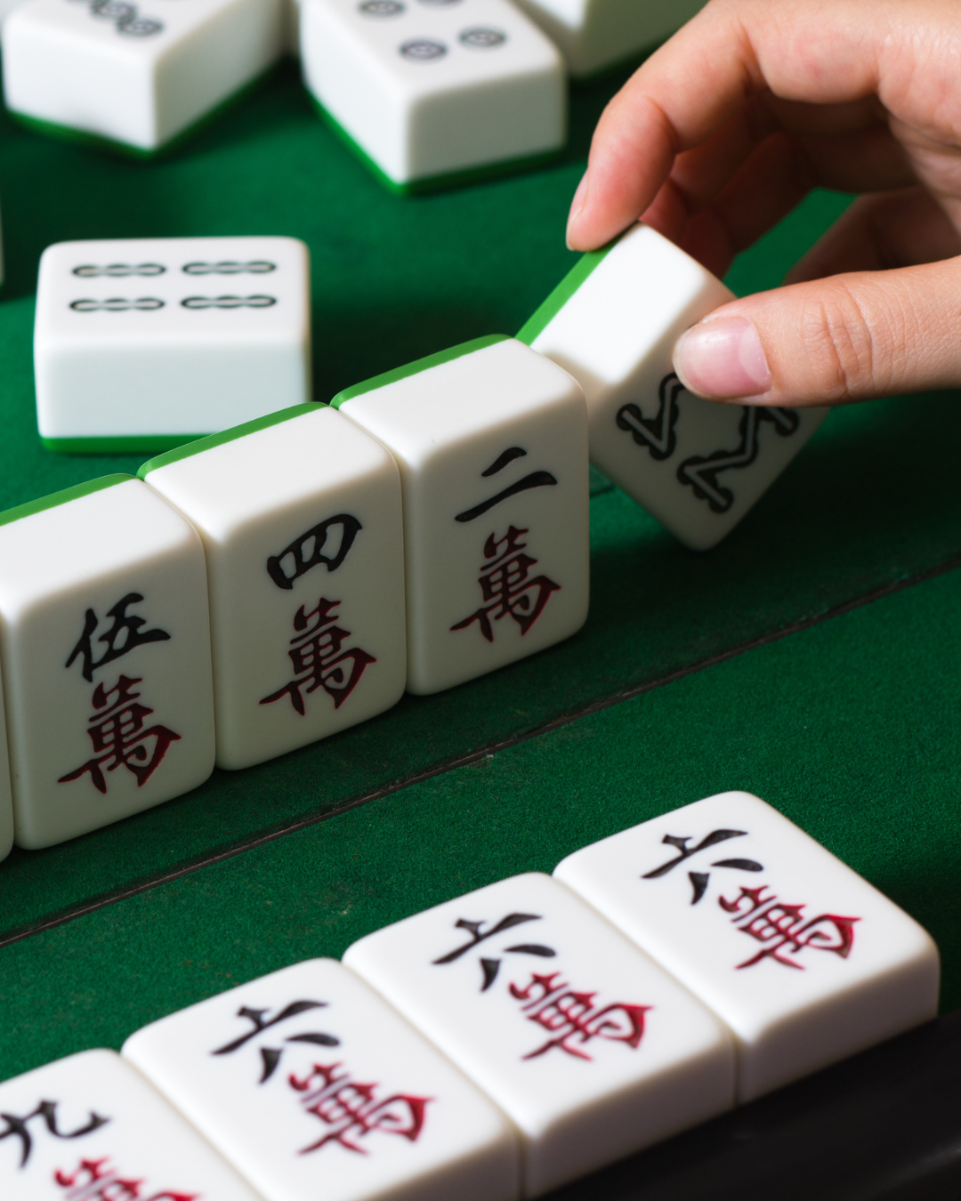 playing mahjong on green table