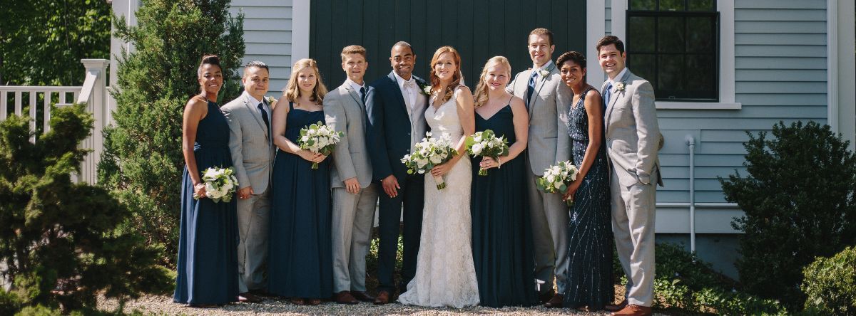 Couple posing with a group outside the Inn at Hastings Park