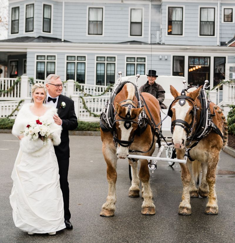 Couple standing outside with a horse and buggy