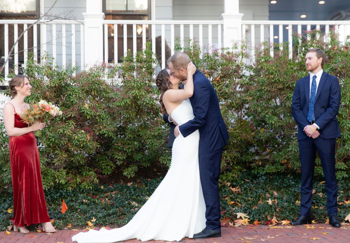 Married couple kissing outside