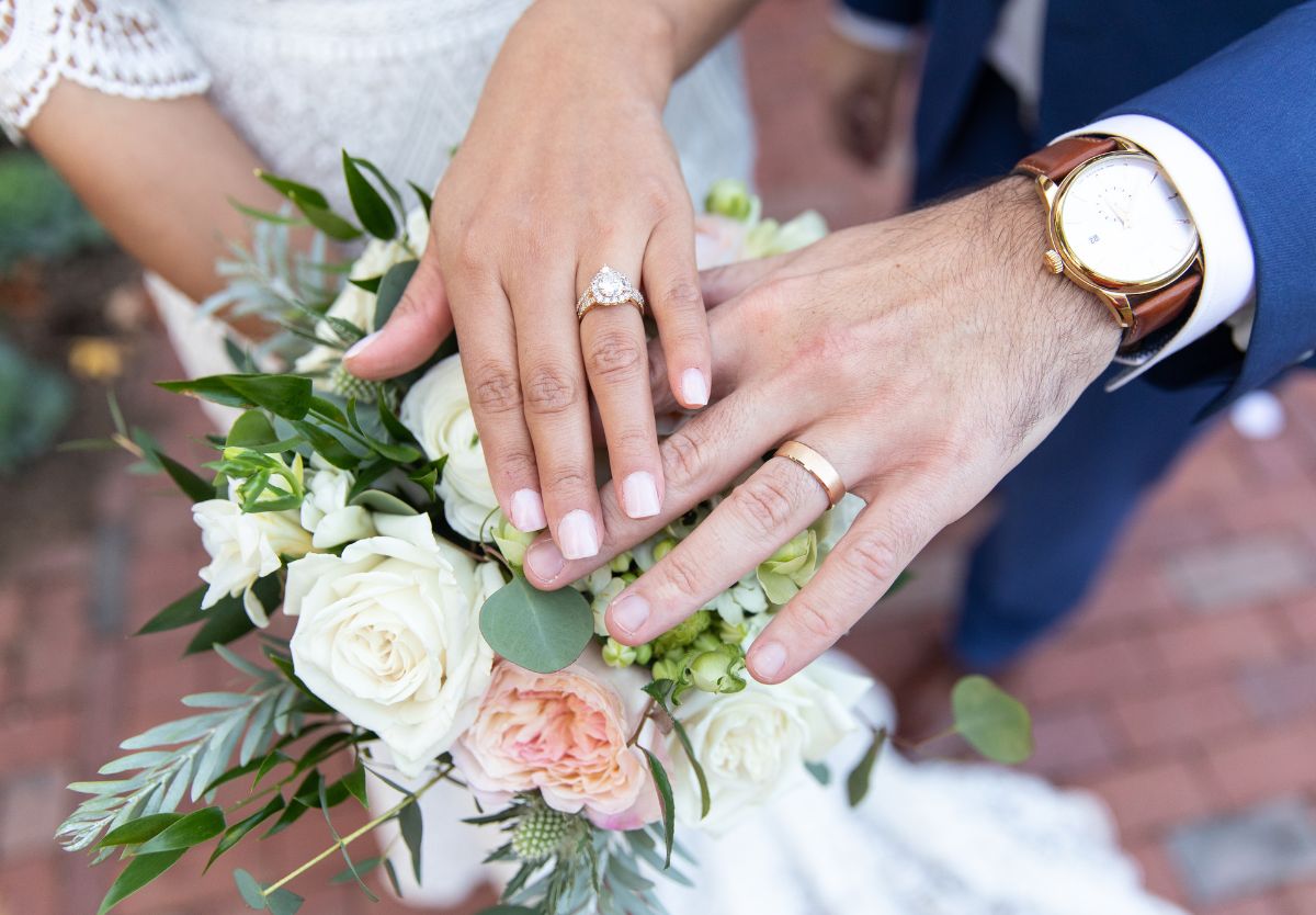 Married couple placing hands on flowers