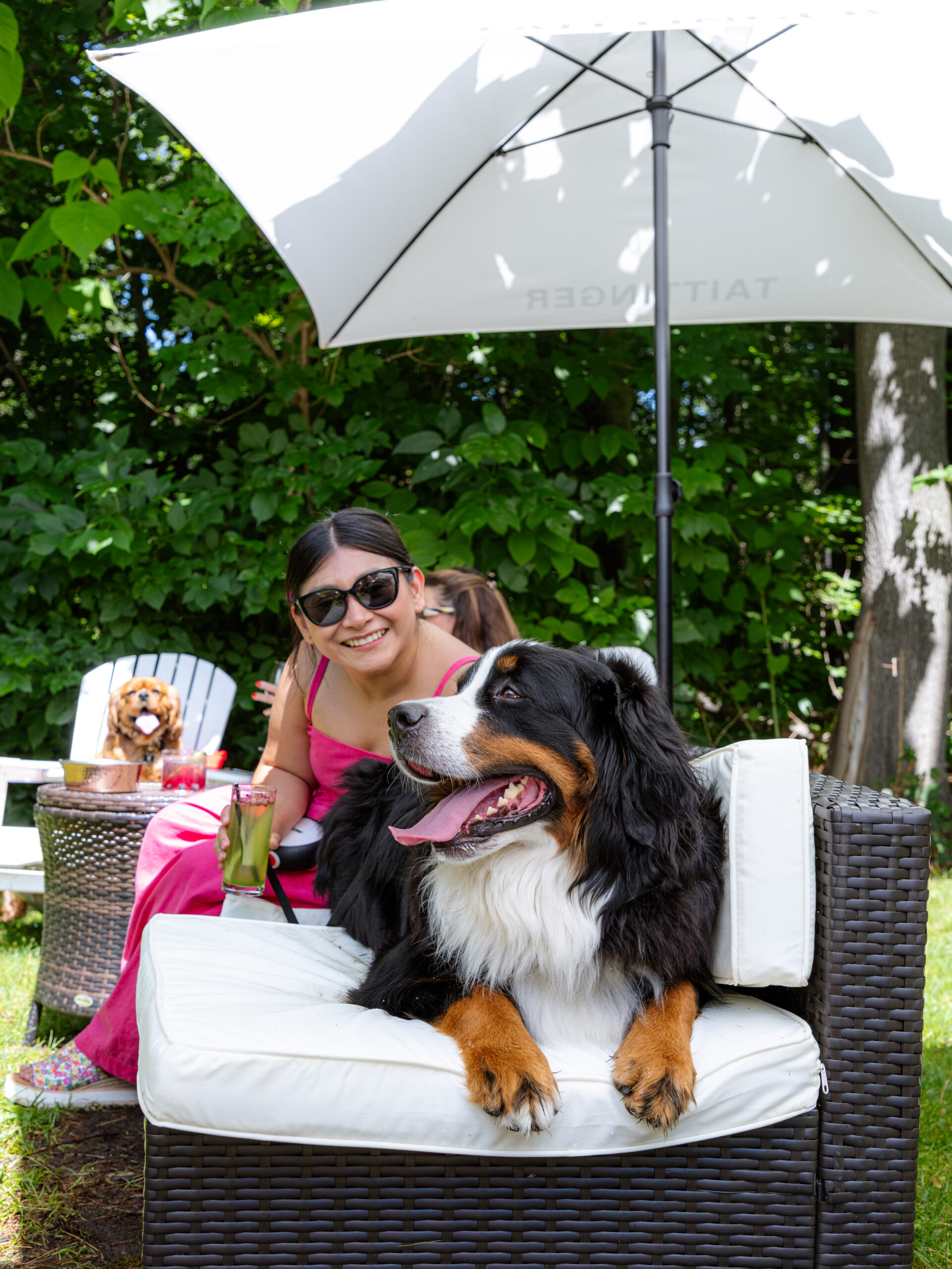 woman with dog and a cocktail in a garden for yappy hour