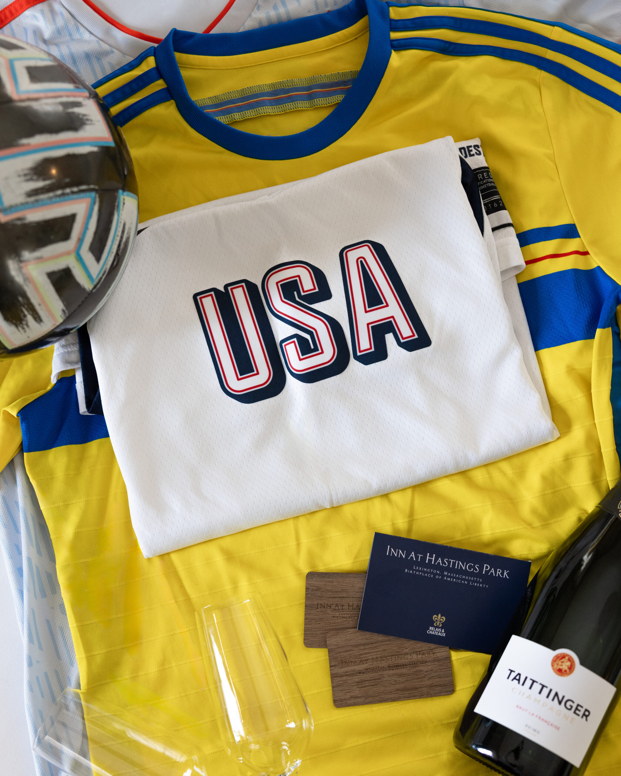 Usa soccer jersey with soccer ball, Taittinger Champagne, champagne glasses and room keys