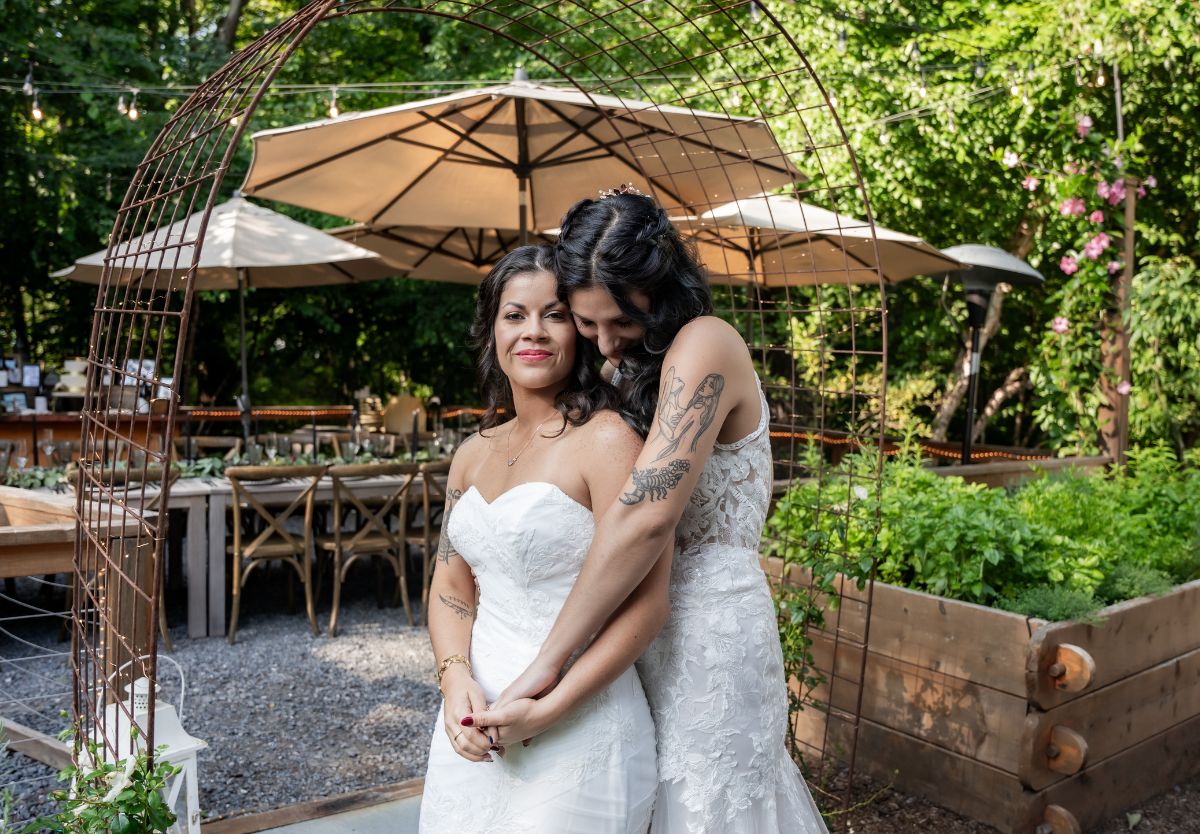 Brides holding each other outside