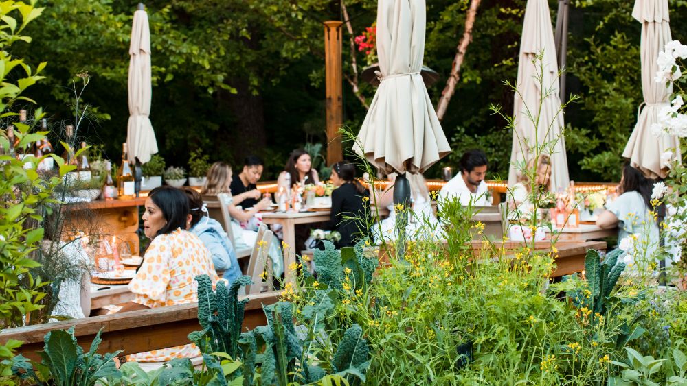 People sitting outside the Inn at Hastings Park