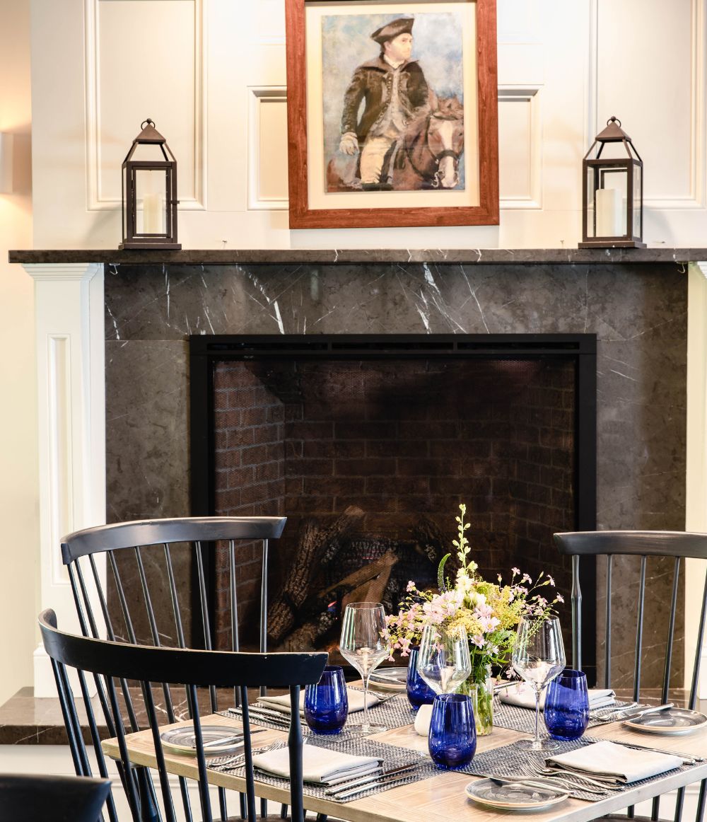 Fireplace with table at the Inn at Hastings Park