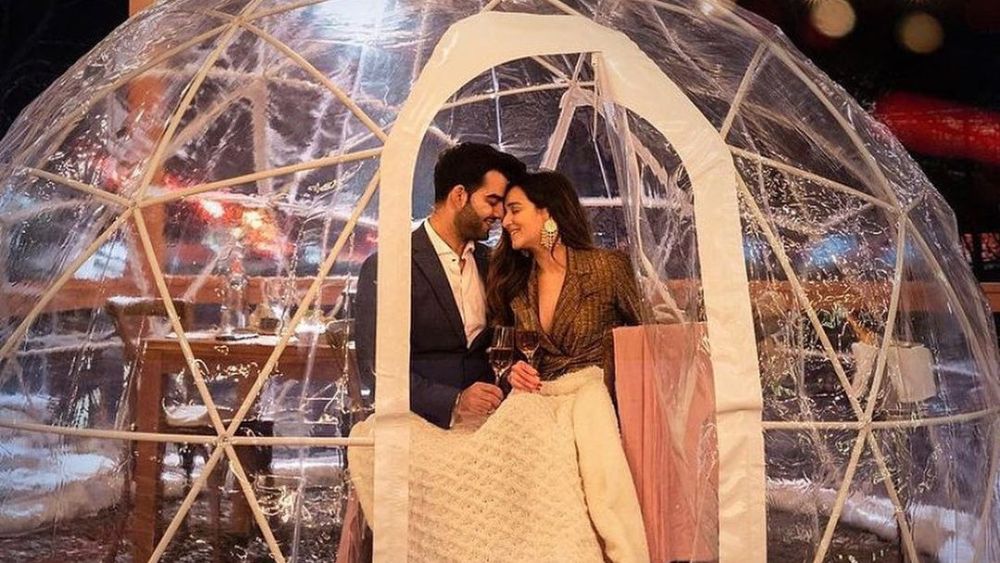 Couple standing in an igloo